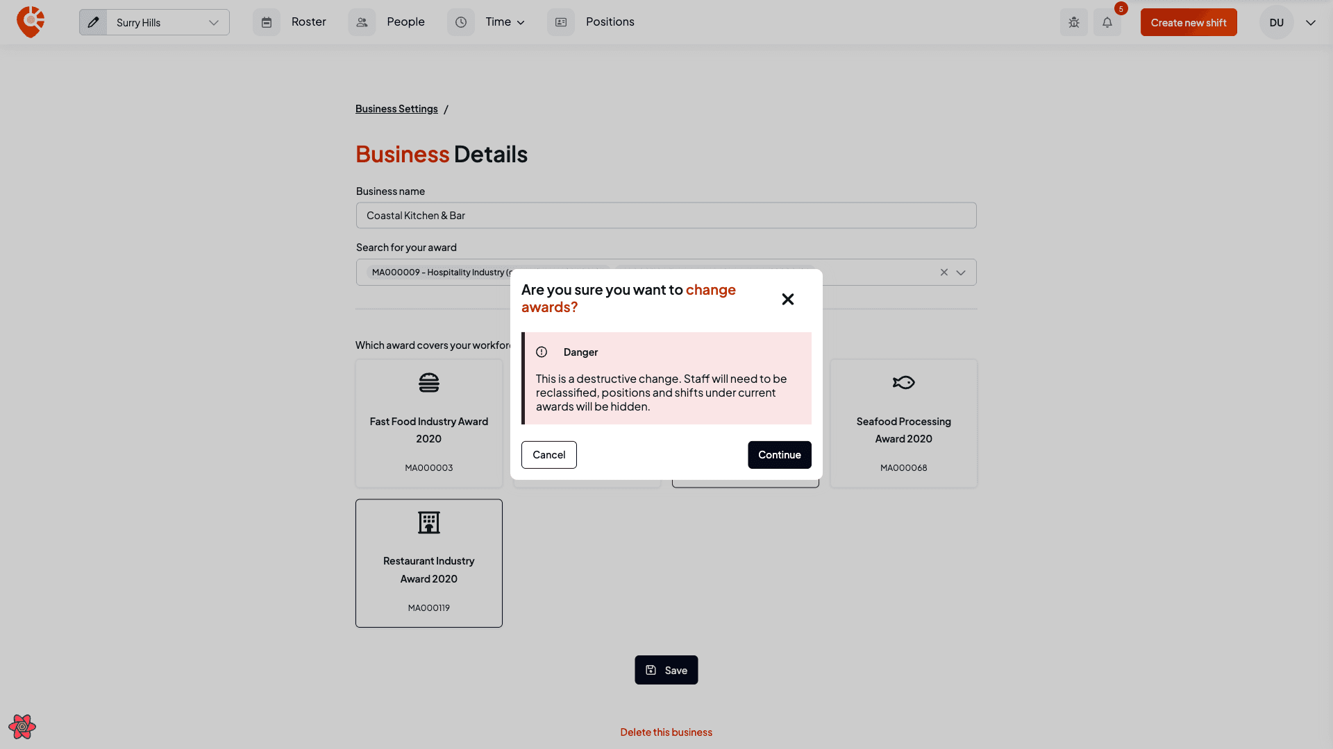 The change-award confirmation dialog warning that staff need reclassifying and positions and shifts will be hidden