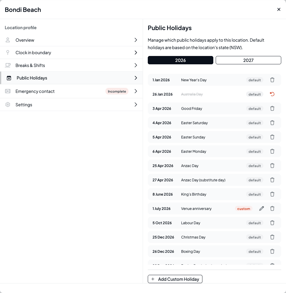 The holiday list showing Australia Day struck through with a Restore action, and a custom Venue anniversary holiday tagged Custom with edit and delete actions